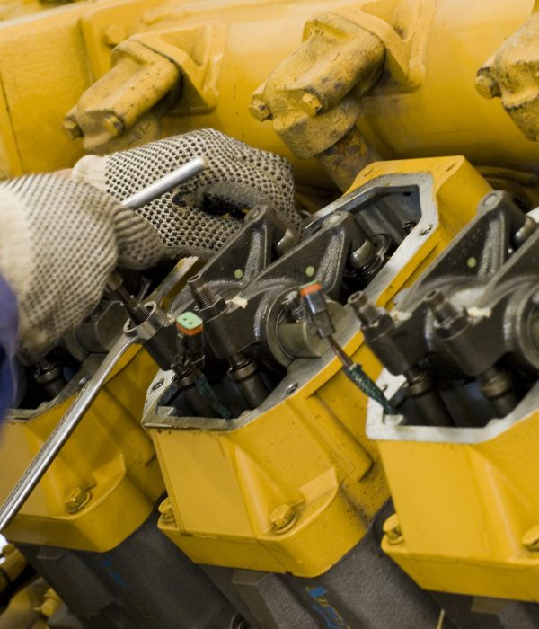 A technician performing periodic engine maintenance in a landfill gas recovery plant